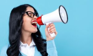Woman using a megaphone for a concept of free advertising
