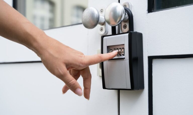 A closeup of a hand unlocking a keysafe outside a customer's house for a pet sitting appointment